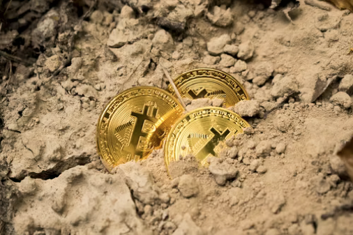 Bitcoins in sand